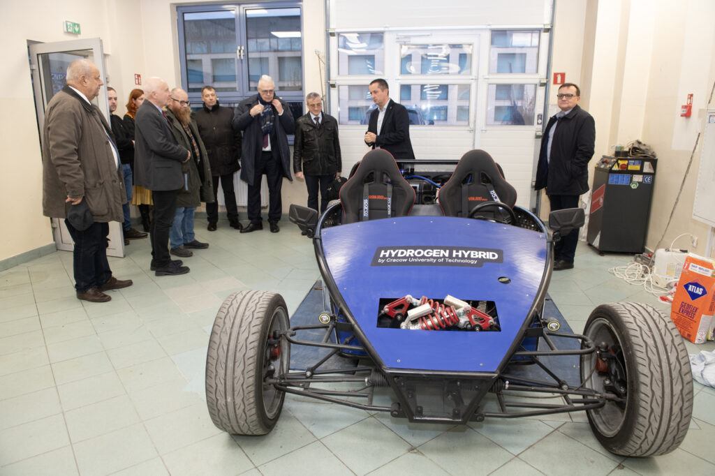 JRC EU delegation during a vist at the Faculty of Mechanical Engineering at PK KUT watching the Hydrogen Hybrid race car developed by PK KUT student team